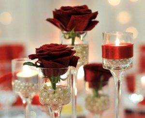 Roses in glasses. Candle in glass